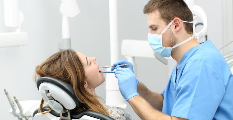 Dentist looking in a patient's mouth