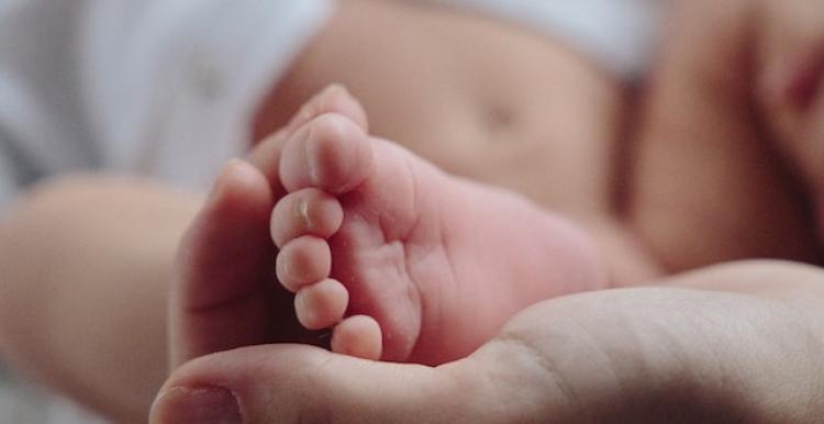 A baby's foot held in a hand