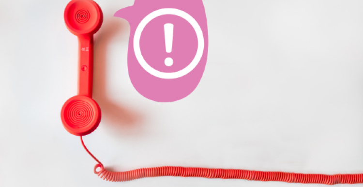 an alert symbol in a speech bubble coming out of a landline telephone receiver