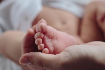 A baby's foot held in a hand