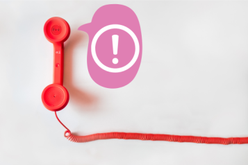 an alert symbol in a speech bubble coming out of a landline telephone receiver