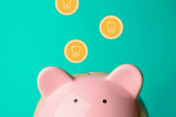 Coins with teeth on falling into a piggy bank